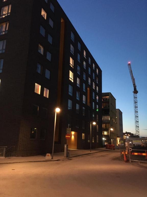a tall building with a crane in front of it at Beautiful 1- Bed Studio in Sollentuna in Sollentuna