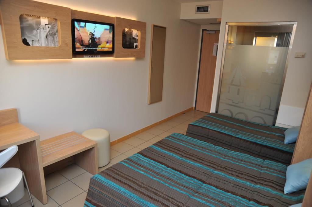 TV a/nebo společenská místnost v ubytování Hotel Espace Cite