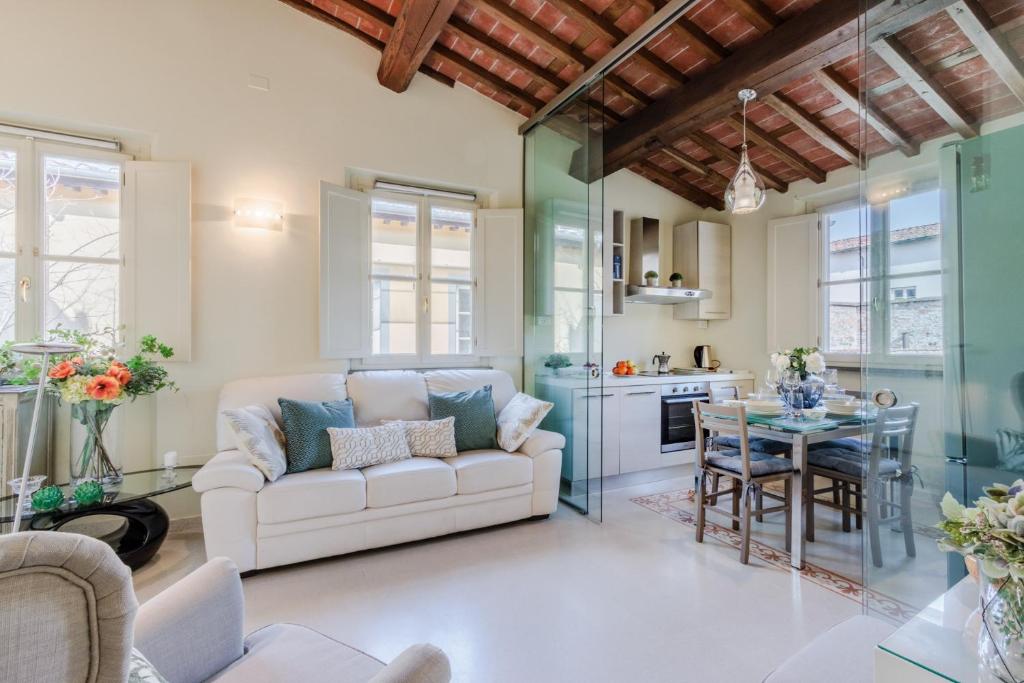 a living room with a couch and a table at Helene Smart Flat with Elevator inside Lucca in Lucca