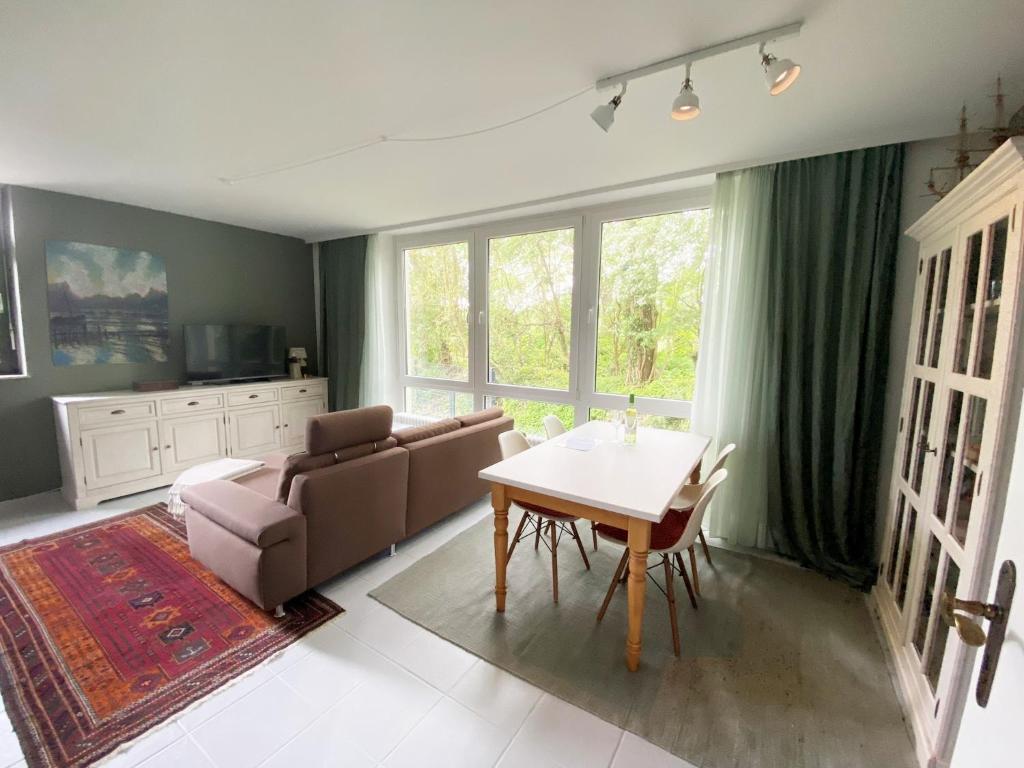 a living room with a couch and a table at Gästehaus am Brockeswald in Cuxhaven