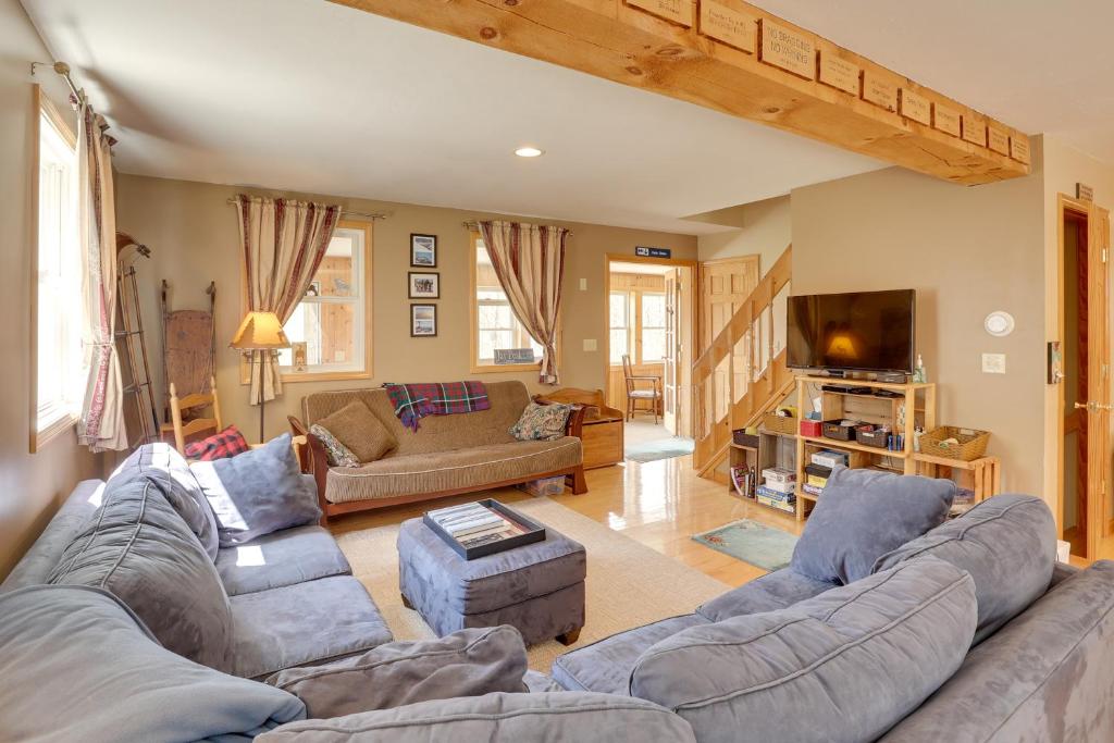 a living room with two couches and a tv at Spacious Jay Peak Vacation Rental with Mountain View in Jay