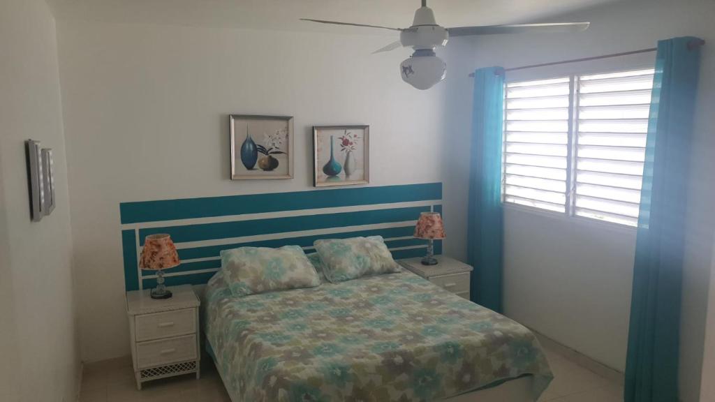 a bedroom with a bed and two night stands at Appartement à Louer à Boca Chica in Boca Chica