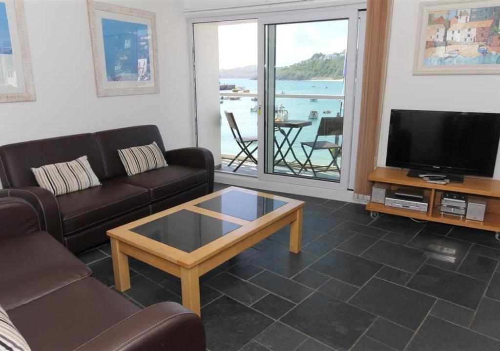 a living room with a couch and a coffee table at 1 White Hart House The Wharf in St Ives