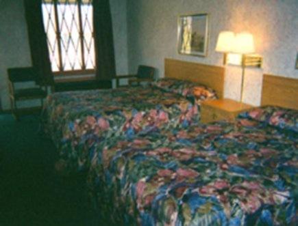 a hotel room with two beds and a window at Relax Inn Richmond in Richmond