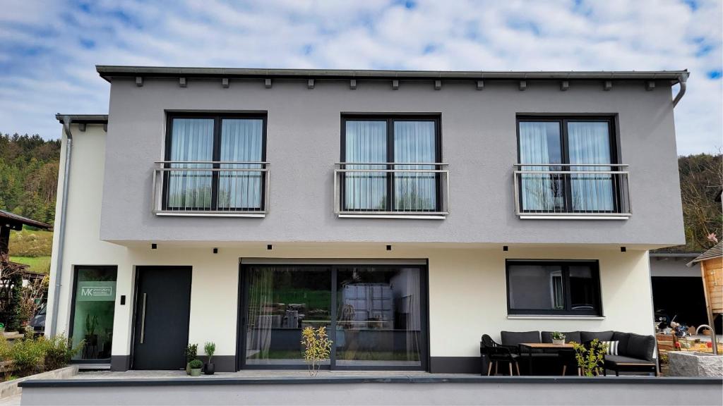 a white house with black windows at MK Appartements in Bad Abbach