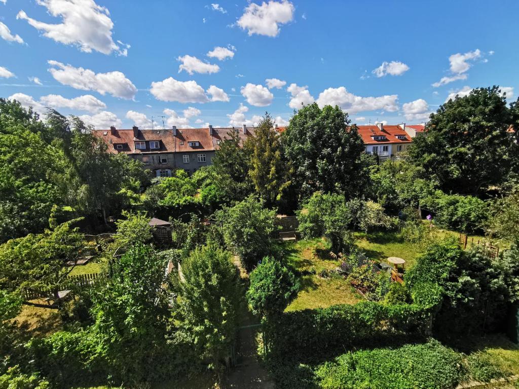 a view of a garden with buildings in the background at Comfortable apartment close to the center and sea in Gdańsk