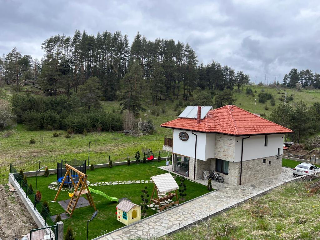 a small house with a playground in a field at 4U LUXURY VILLA in Dospat