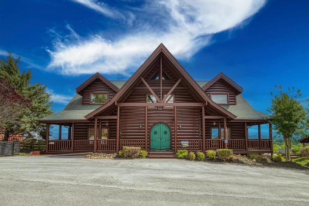 a log home with a green door at Serenity Mountain Pool Lodge in Sevierville