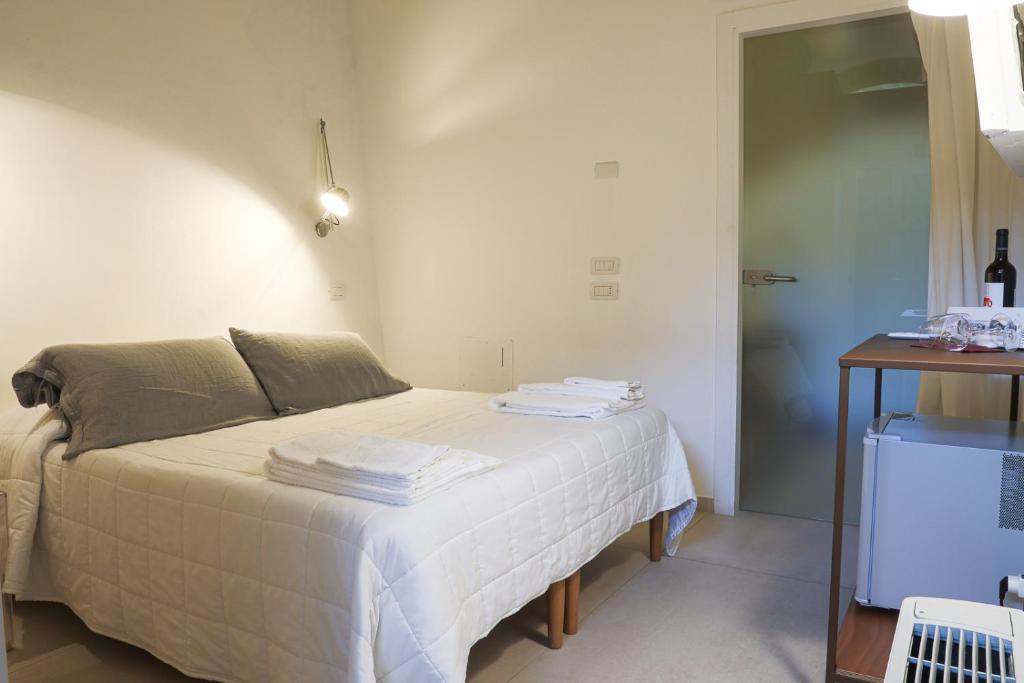 Postel nebo postele na pokoji v ubytování Il Carrubo residenza Walk&Stay