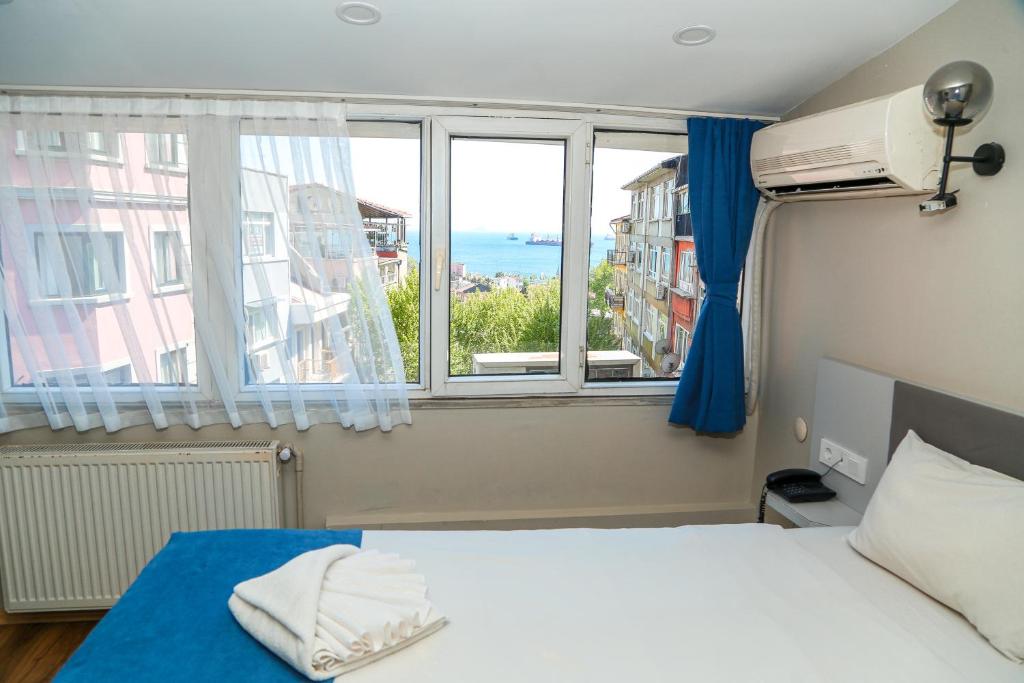 a bedroom with a bed and a large window at Asitane Life Hotel in Istanbul