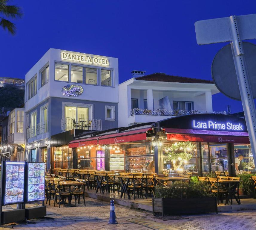 a restaurant with tables and chairs in front of a building at Dantela Butik Hotel in Cesme