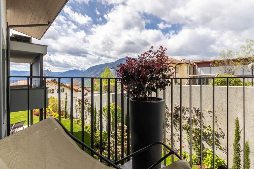 a balcony with a plant in a vase at Mali Apartments Balcony in Tirolo