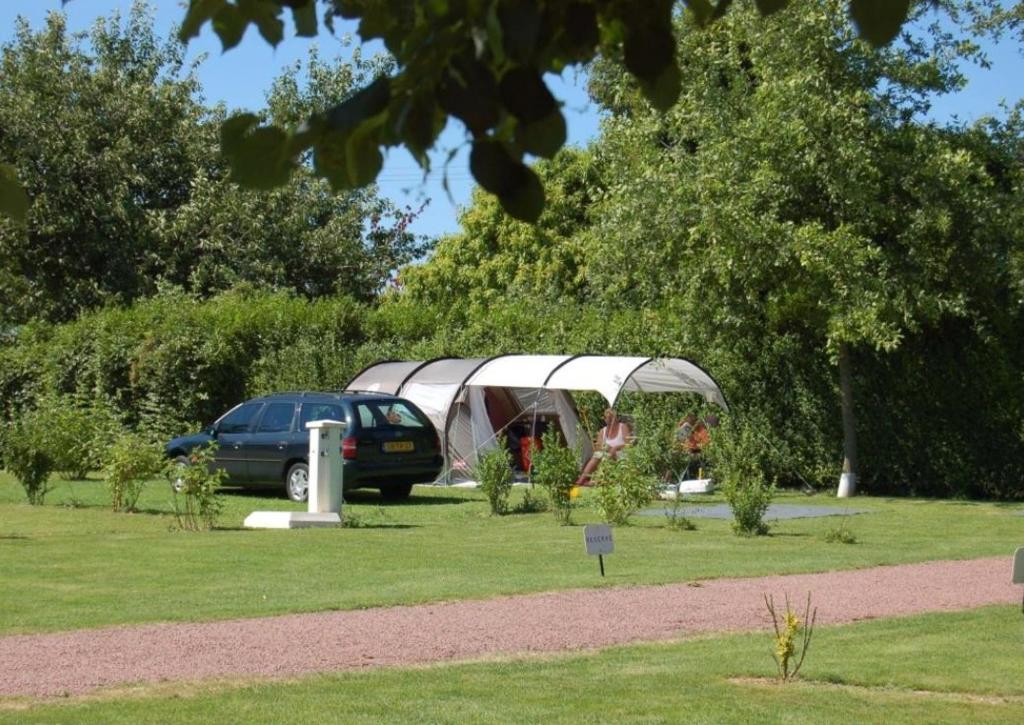 a car parked in a garden with a tent at Les Insolites du vélodrome d&#39;Albert in Albert