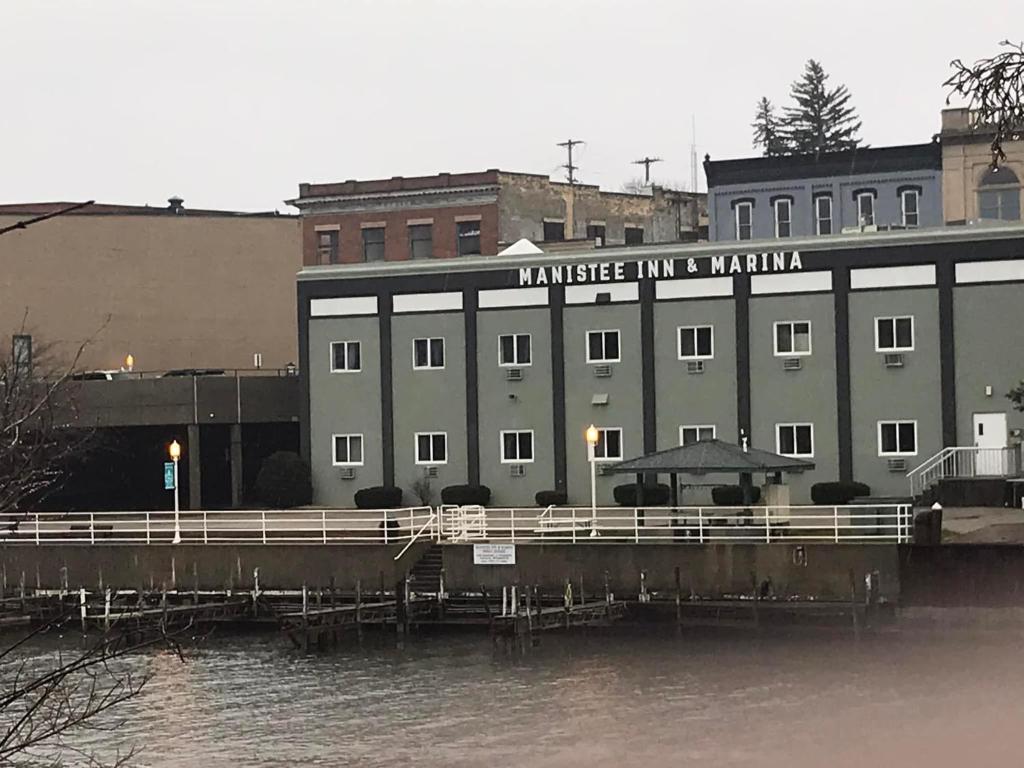 a building next to a body of water at Manistee Inn & Marina in Manistee