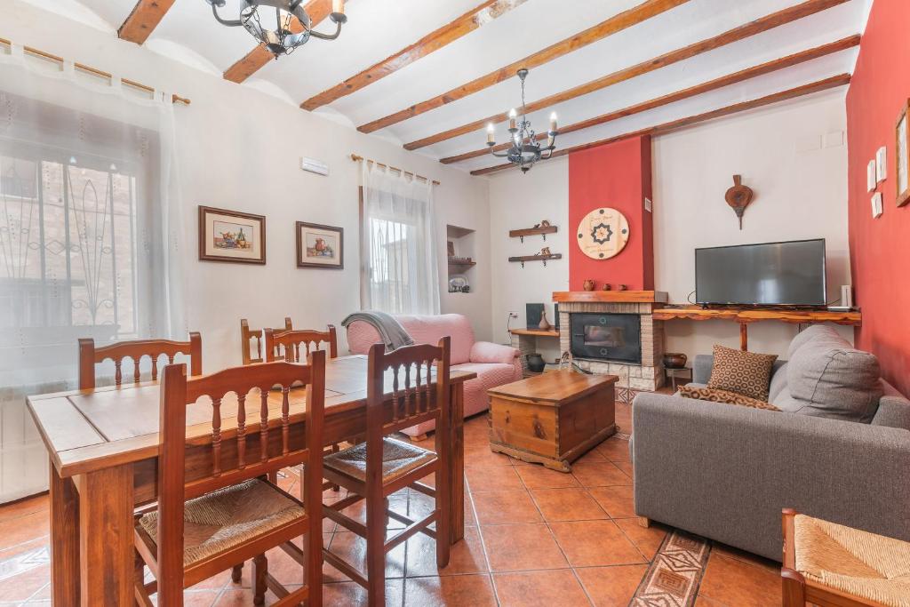 a living room with a table and a tv at Barranco de las Maravillas in Teruel