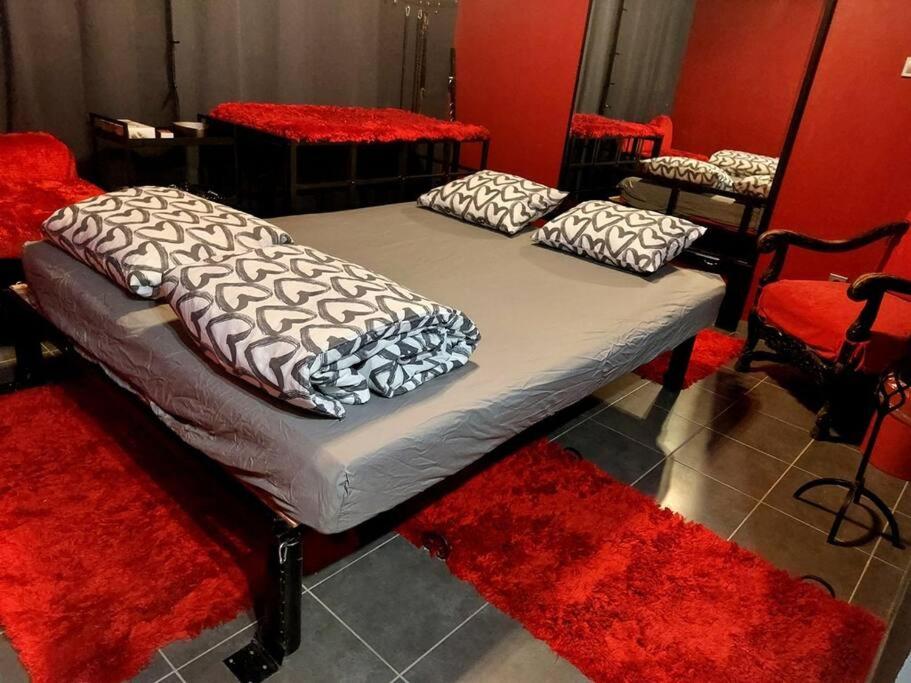 a bed with two pillows on it in a room at Budapest BDSM Studio in Budapest