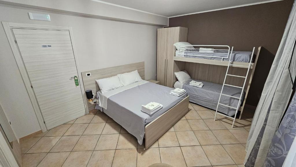 Habitación pequeña con cama y escalera en B&B Da Kociss, en Mileto