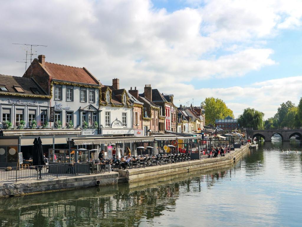 a group of buildings next to a river at Appartement Prestige - Amiens in Amiens