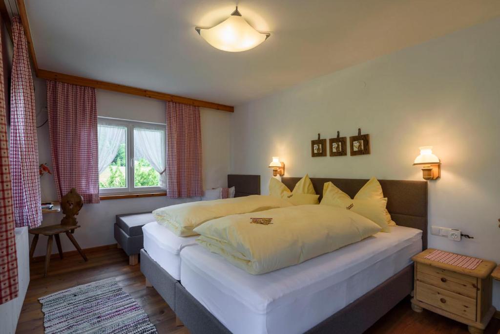 a bedroom with a large bed and a window at Gasthof Waldwirt in Russbach am Pass Gschütt