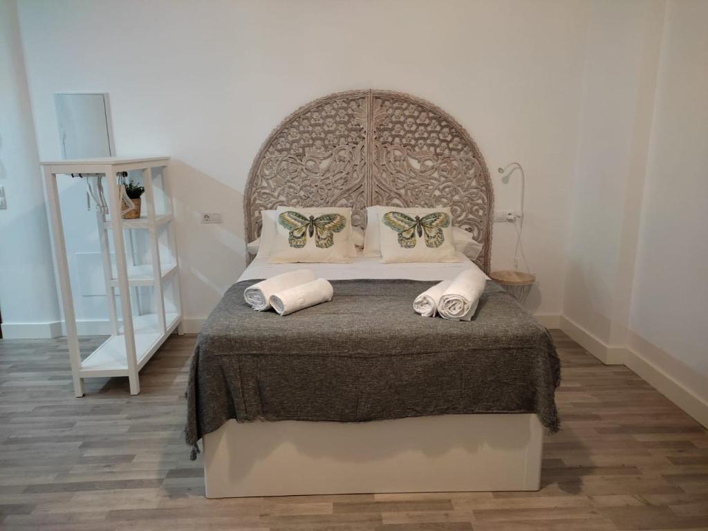a bedroom with a large bed with butterfly pillows at VFT Puerta de Córdoba in Baeza