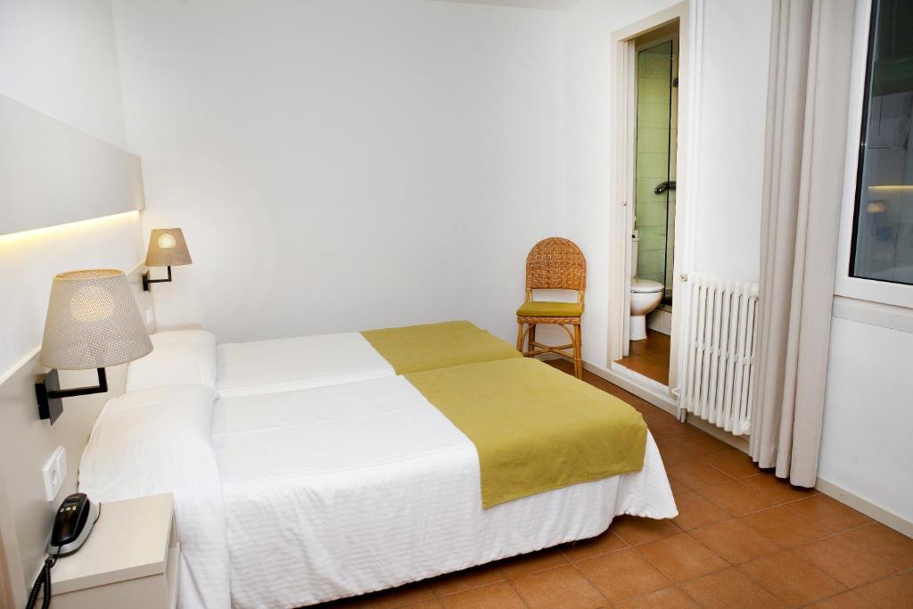 Postel nebo postele na pokoji v ubytování Hotel Ubaldo