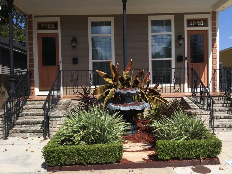 a house with a fountain in front of a house at Amazing 3bedroom townhome, in Historic Dryade City in New Orleans