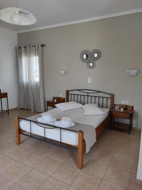 a bedroom with a large bed with white pillows at Vythos in Adamas