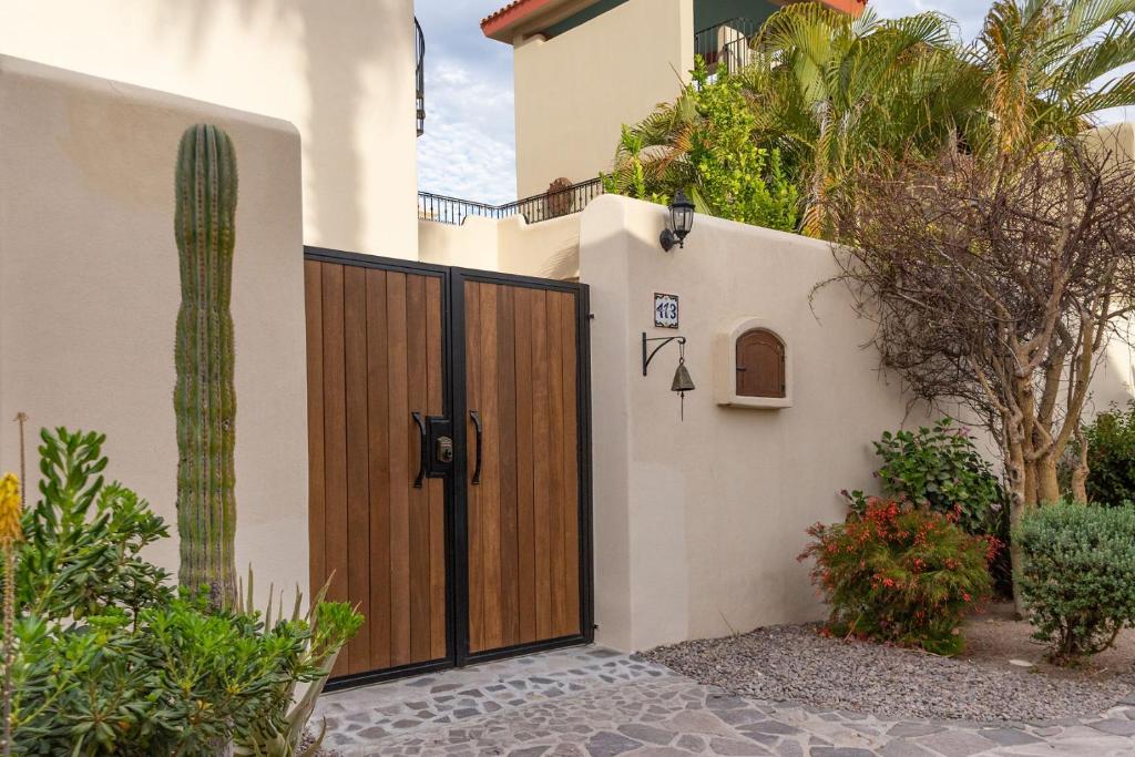 a wooden gate to a house with a cactus at Casa Gora by Casago in Loreto