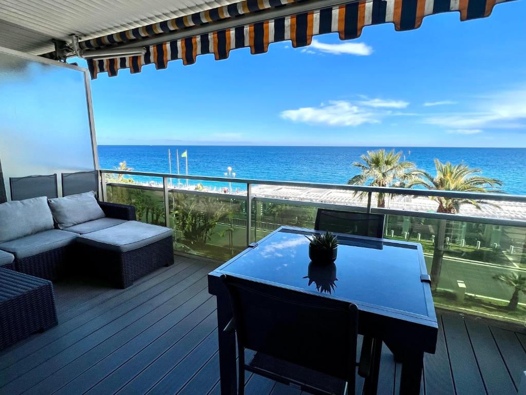 a balcony with a table and a view of the ocean at Apart-a-Nice : A Breathtaking View on the Sea in Nice