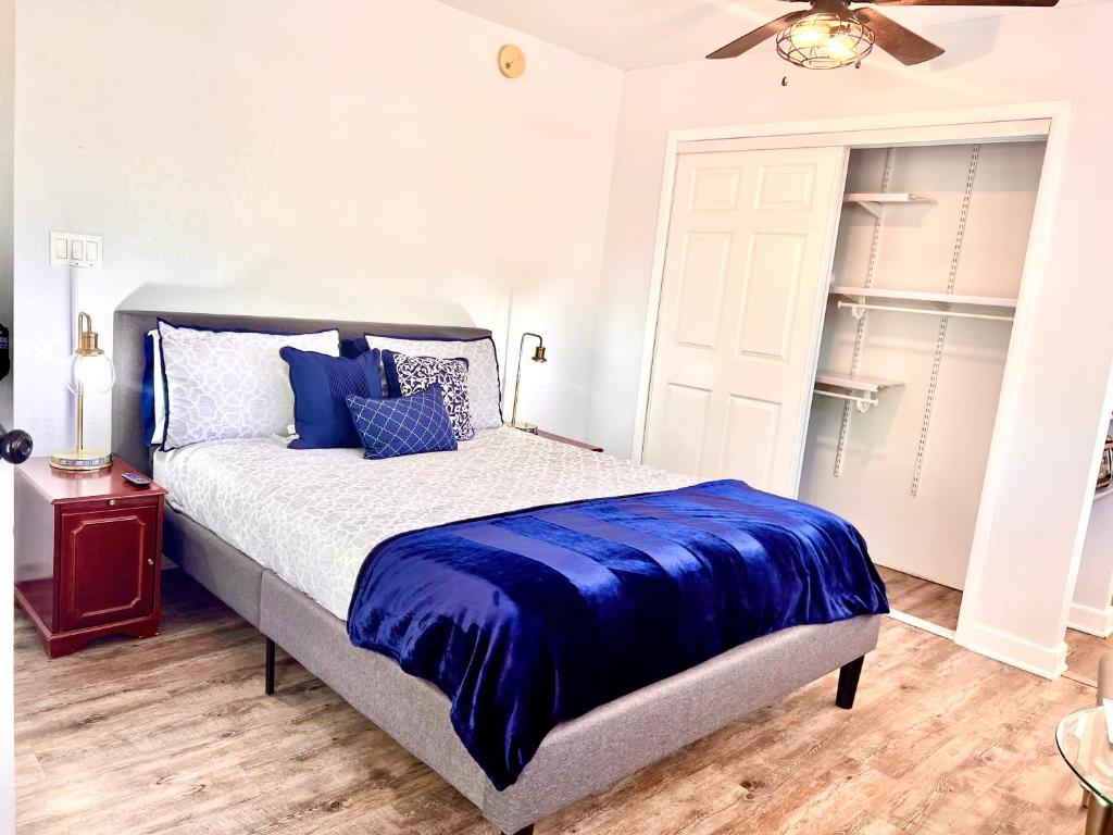 a bedroom with a bed with a blue comforter at Upgraded, Stylish & Comfy 1 Bedroom/1 Bath Studio in Payson