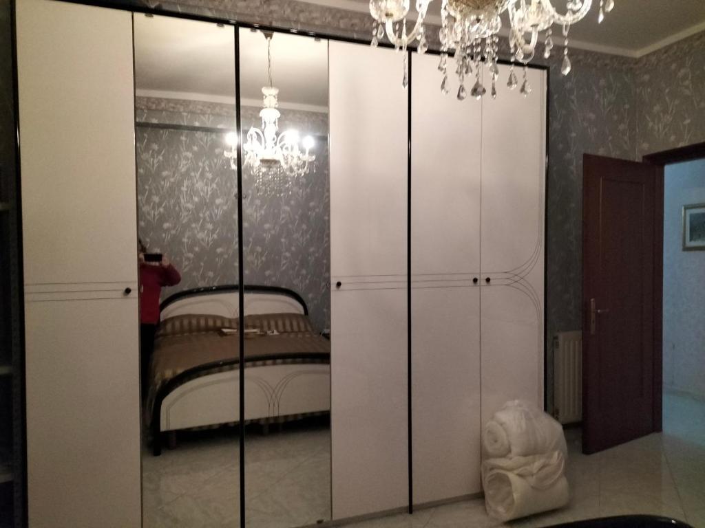 a bedroom with a white closet with a bed at Maremonti in Zafferana Etnea
