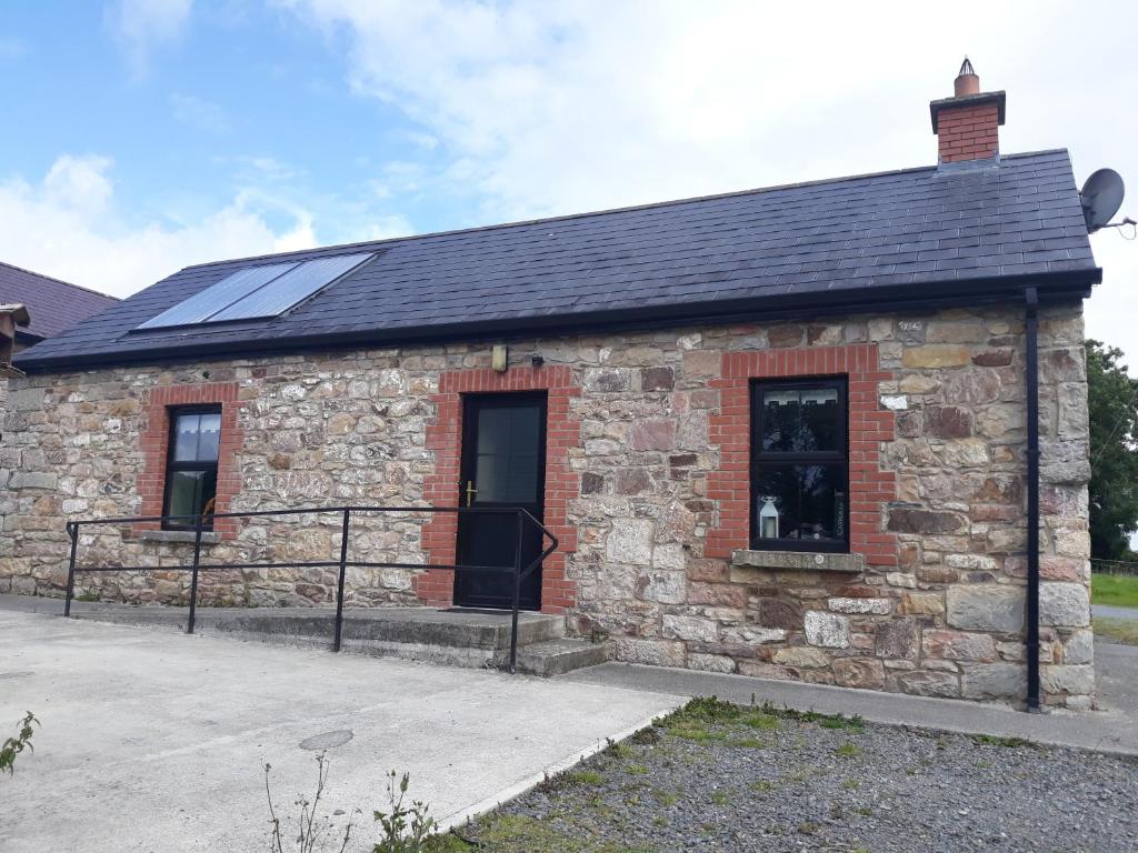 a stone building with solar panels on it at Rathgillen Lodge in Nobber