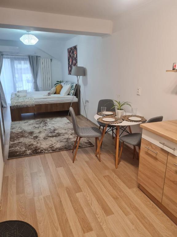a living room with a bed and a table and chairs at Flowers in the Center in Oradea