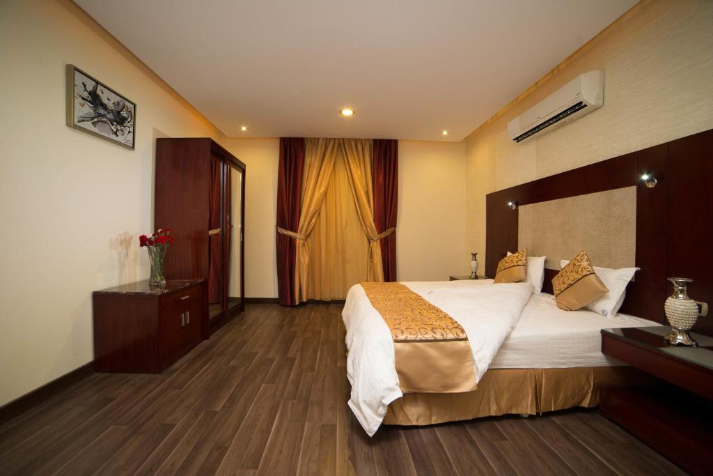 Postel nebo postele na pokoji v ubytování رؤوم إن للشقق الفندقية-Raoum Inn Hotel Apartments
