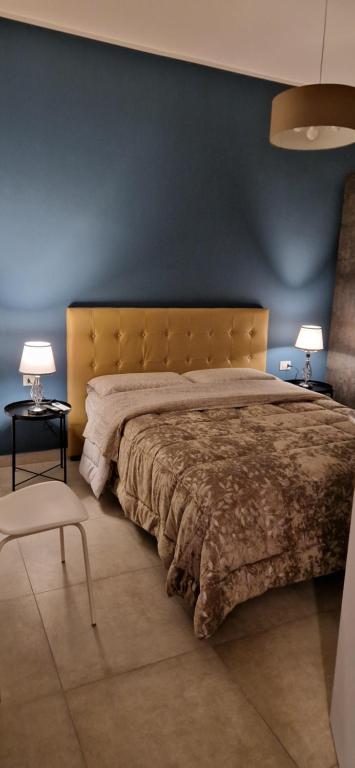 una camera con un grande letto con una parete blu di casa vacanze Nonna Maria a Caltagirone