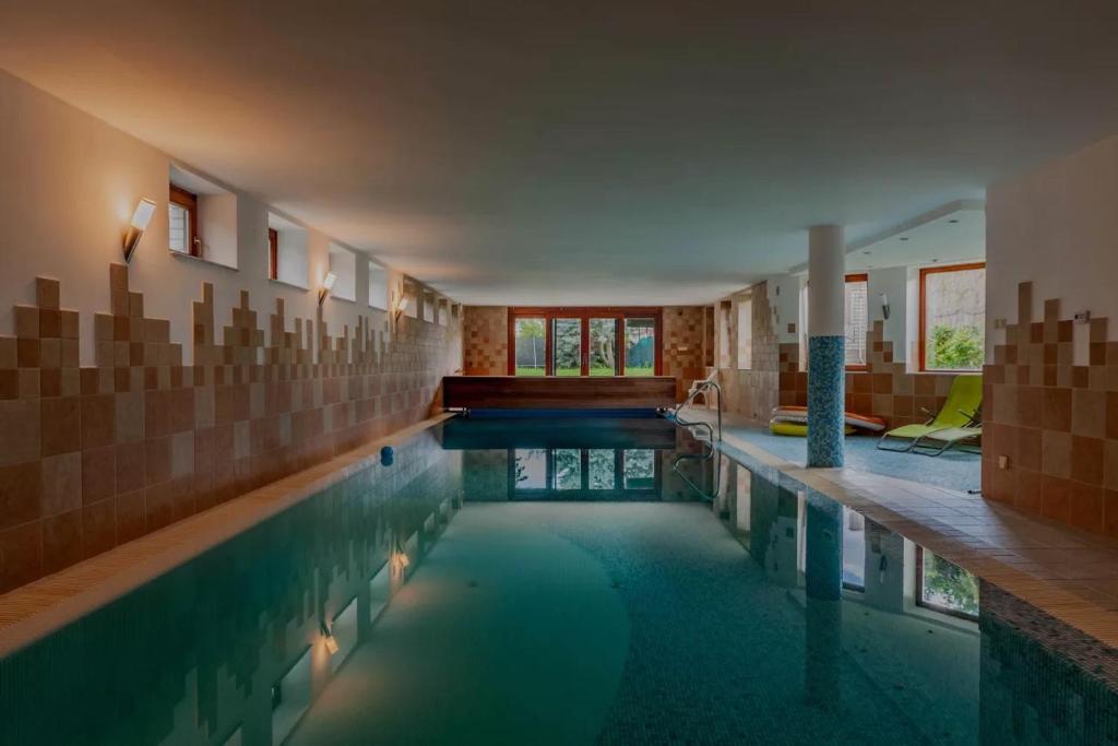 a large swimming pool in a house with a swimming pool at Relax House Budapest in Budapest