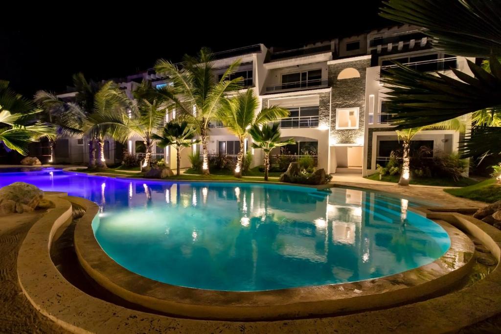 a swimming pool in front of a house at night at Caribbean Star - Estrella Dominicus Bayahibe in Bayahibe