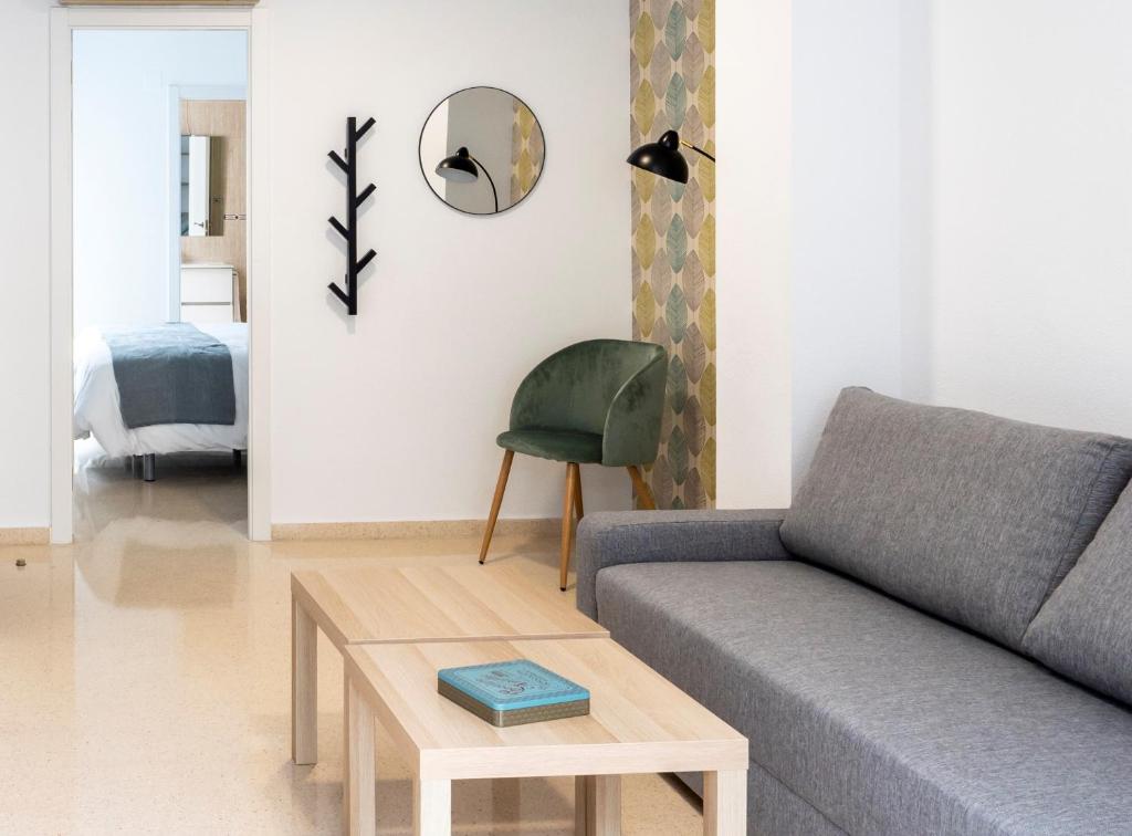 a living room with a couch and a table at CALMA Apartments in Benidorm