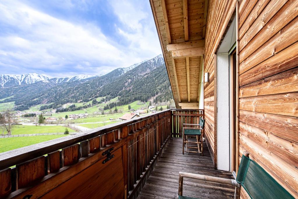 a balcony of a cabin with a view of mountains at Apartments Nature Apis Landheim in Anterselva di Mezzo