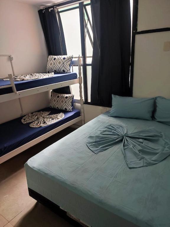 a bedroom with a bed with a bow on it at Hostel Princess Copacabana in Rio de Janeiro