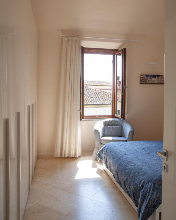Posteľ alebo postele v izbe v ubytovaní GoldenTuscany Apartment