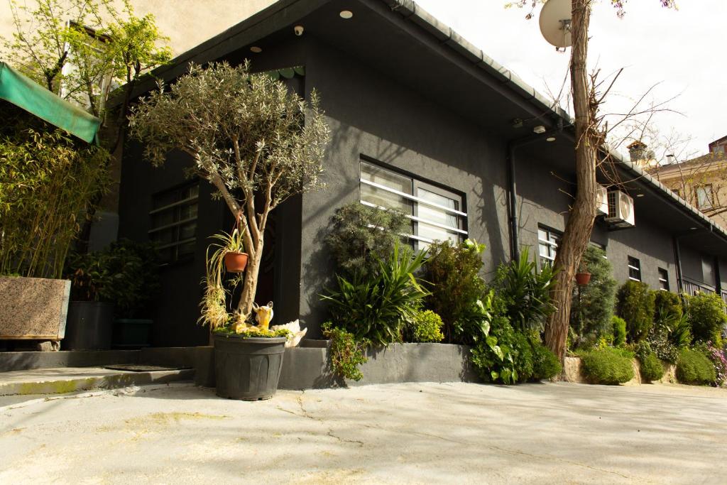 a black house with plants in front of it at Cozy Garden Flat by SUMMITVISTA in Istanbul