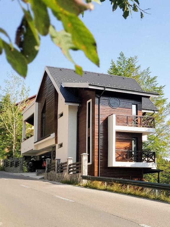 a house with a black and white at Casa Larisa Antonia Apartments in Sinaia