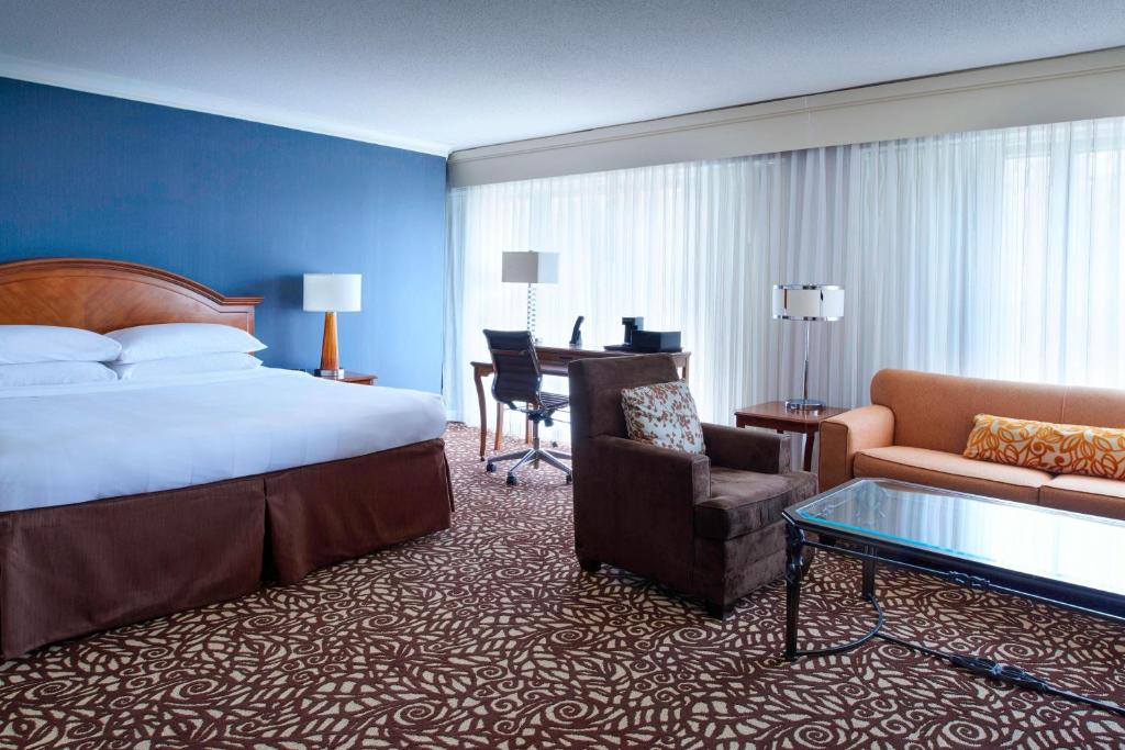 Habitación de hotel con cama, silla y escritorio. en Milwaukee Marriott West, en Waukesha