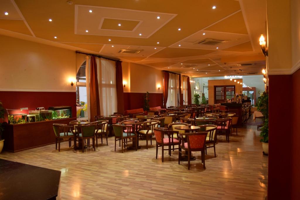 a restaurant with tables and chairs in a room at Aktea Beach Village in Ayia Napa