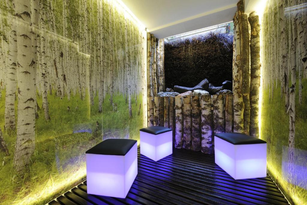 two stools in a room with a green wall at Hotel Saalbacher Hof in Saalbach-Hinterglemm