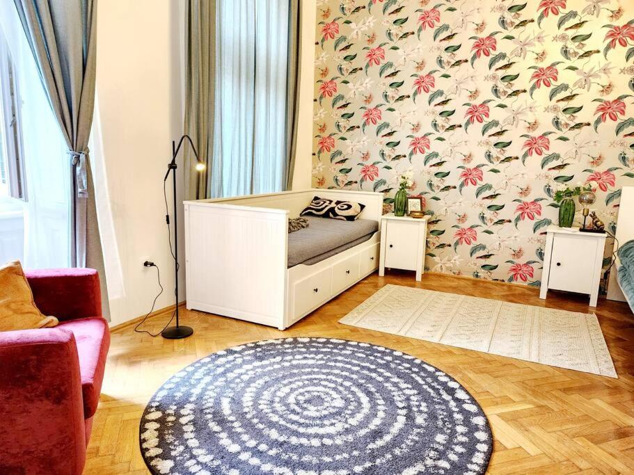 a living room with a bed and a rug at NEW LISTING IN THE HEART OF BUDAPEST Apartment Kamilla in Budapest