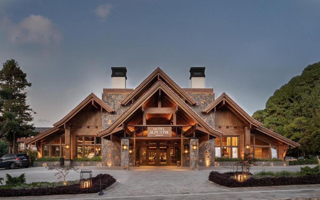 a lodge with a large building with at Hotel Alpestre in Gramado