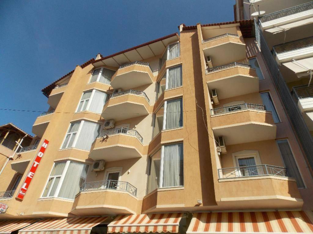 a tall building with balconies on the side of it at Oda`s Room in Sarandë