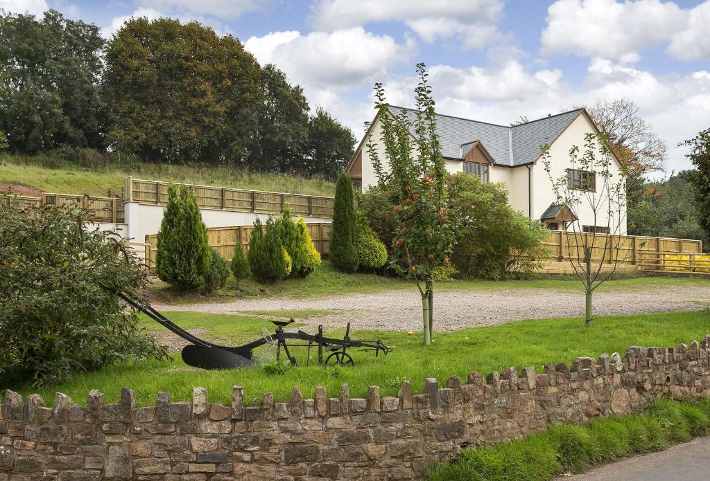 a bike laying in the grass in front of a house at Holywell House 8 Guests in Wellington